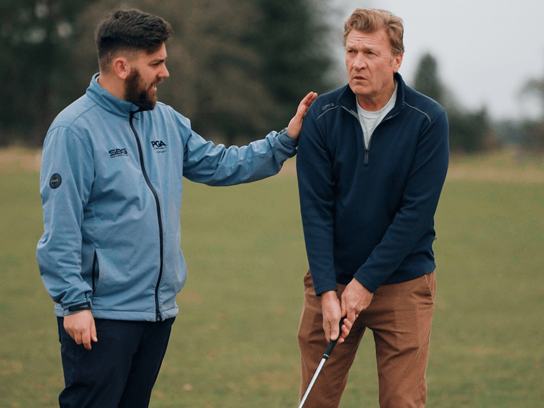 Shay Brennan coaching a golfer at Belton Park